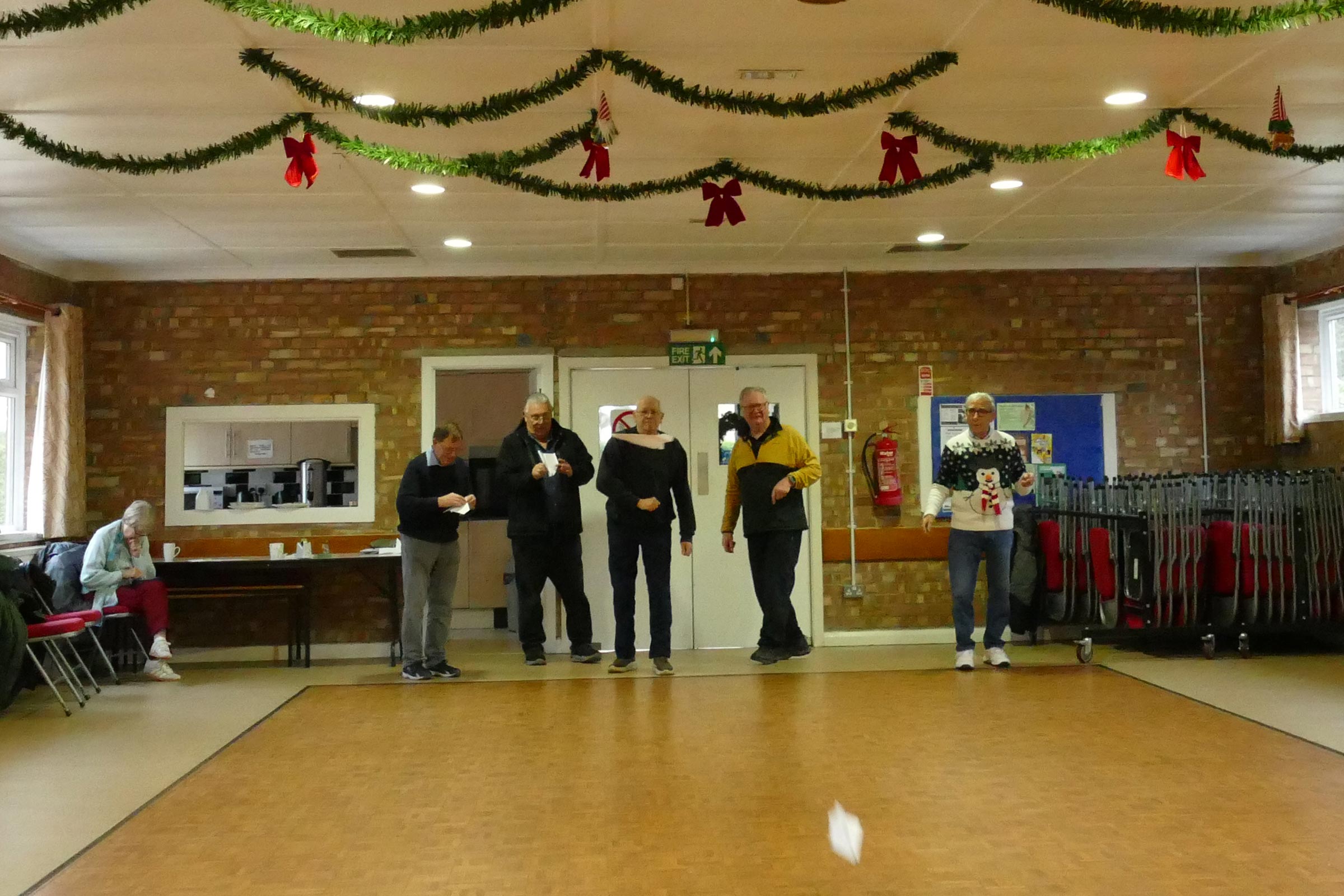 The aim is to get your paper dart or glider to land as near to a mark on the floor to win the money PMFC Christmas party/auction 2025.